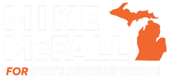 A campaign logo for Mike McFall featuring his name in bold text. The logo includes an outline of the state of Michigan in orange, positioned to the right of the text. The slogan "FOR STATE REPRESENTATIVE" is displayed underneath in a smaller font.